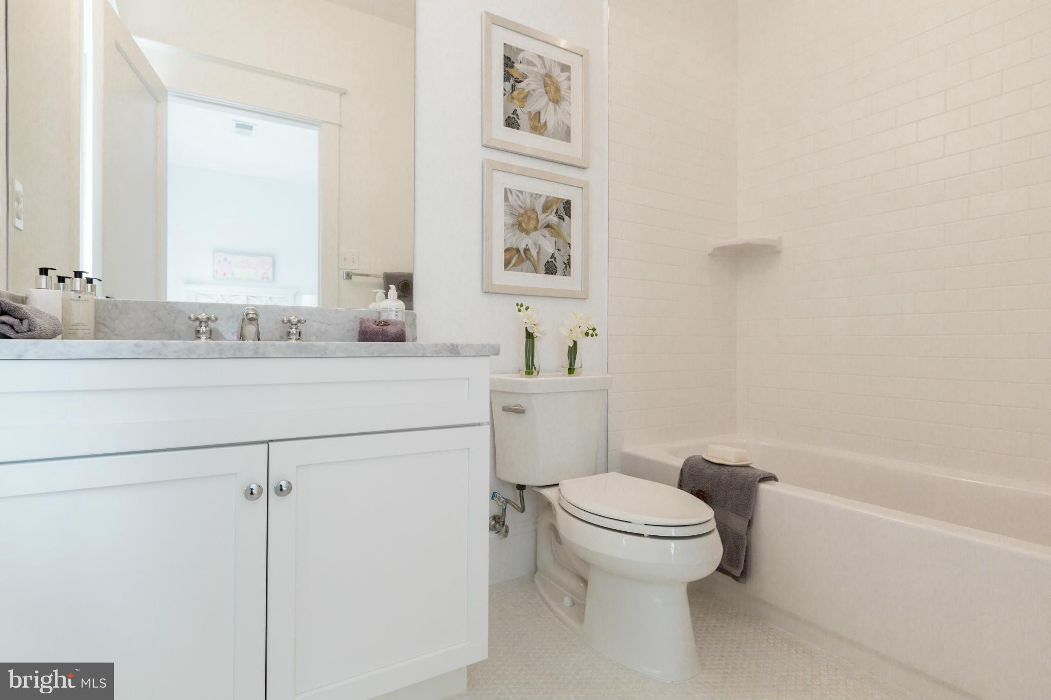2735 Lorcom Lane Arlington, VA 22207 - Photo 24 of 30 a bathroom with a granite countertop toilet sink and mirror