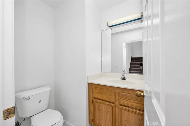 a bathroom with a sink toilet vanity and mirror
