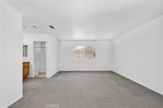 an empty room with a empty space and windows