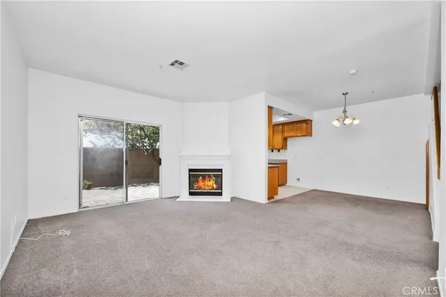 an empty room with entrance and windows