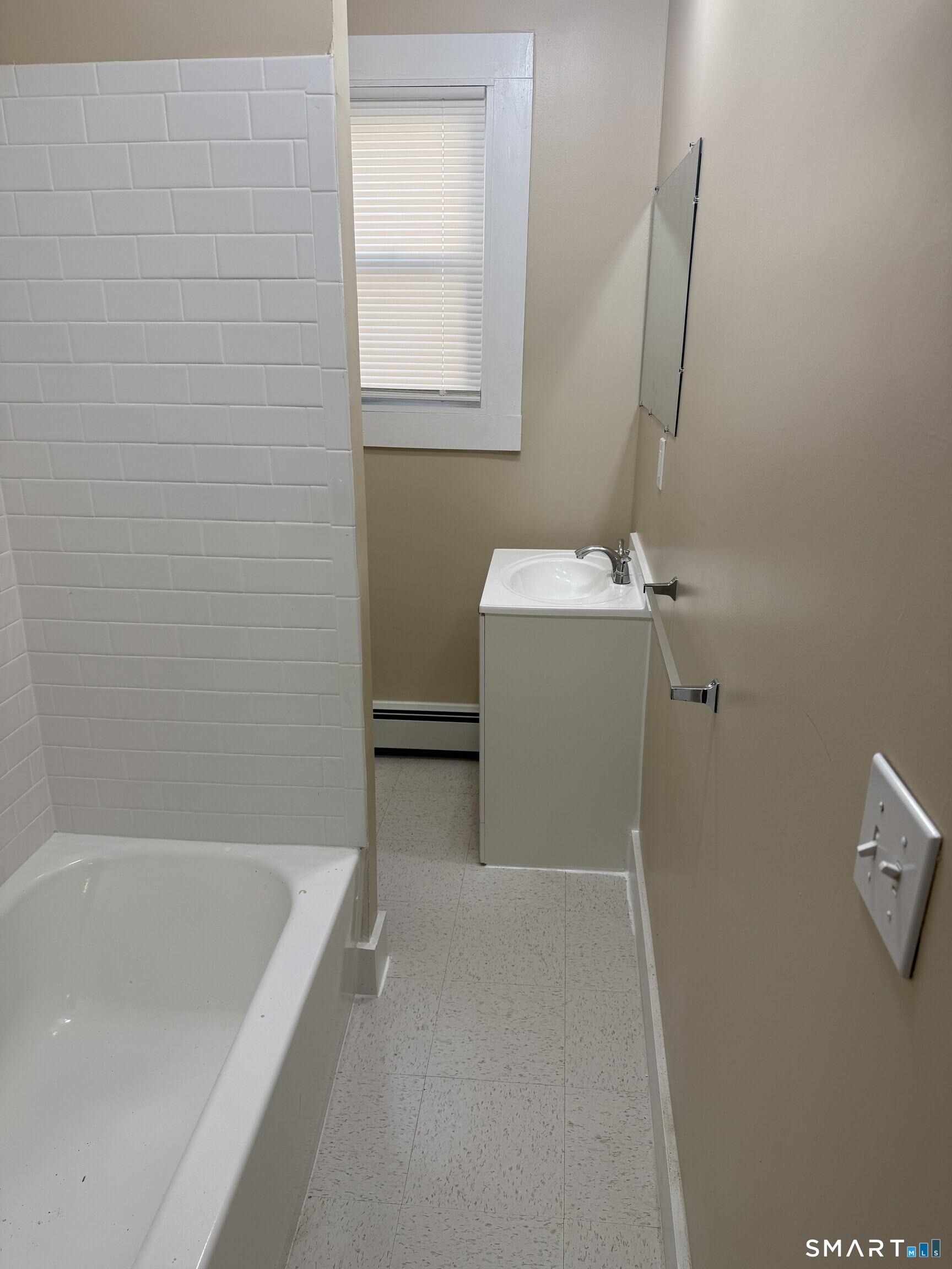 597 Ogden Street Bridgeport, CT 06608 - Photo 6 of 10 a bathroom with a bathtub