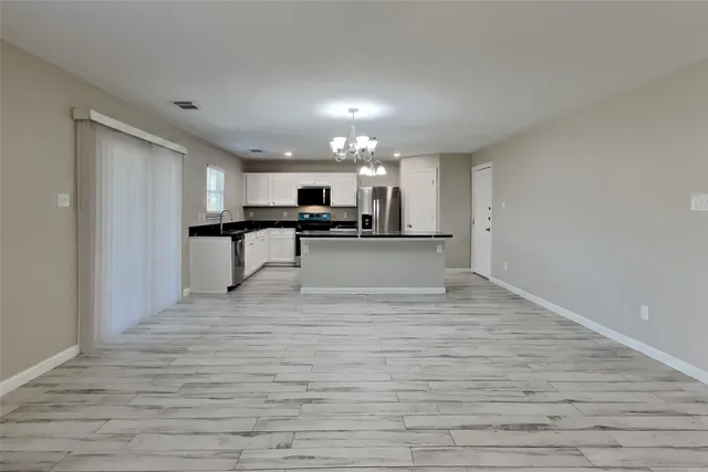 a view of kitchen with sink microwave and stove