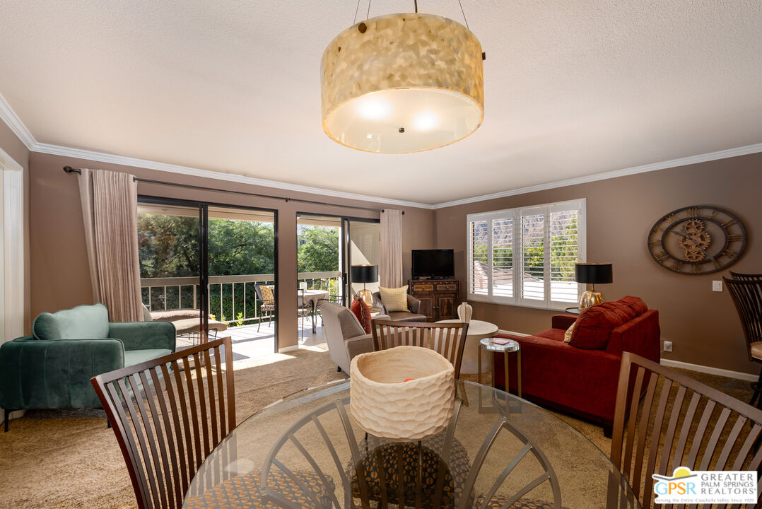 325 East Via Escuela, Unit 324 Palm Springs, CA 92262 - Photo 11 of 29 a living room with furniture and a large window