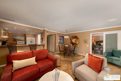 a living room with furniture a rug and a large window