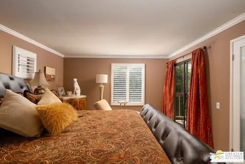 a bed room with a bed and a large window