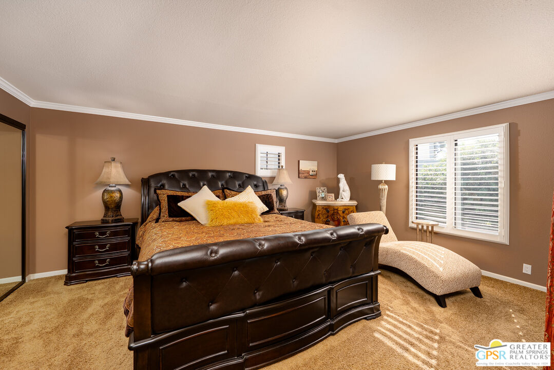 325 East Via Escuela, Unit 324 Palm Springs, CA 92262 - Photo 15 of 29 a bedroom with a bed and a window