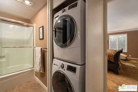 a view of a bedroom with washer and dryer