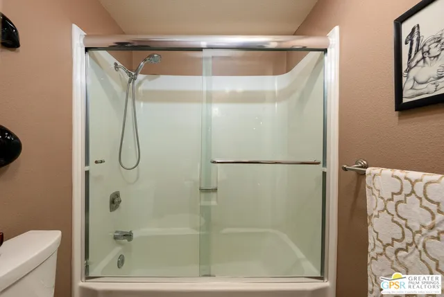 a bathroom with a glass shower door