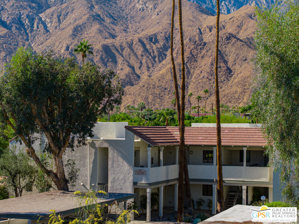 325 East Via Escuela, Unit 324 Palm Springs, CA 92262 - Photo 2 of 29 a front view of a building with garden