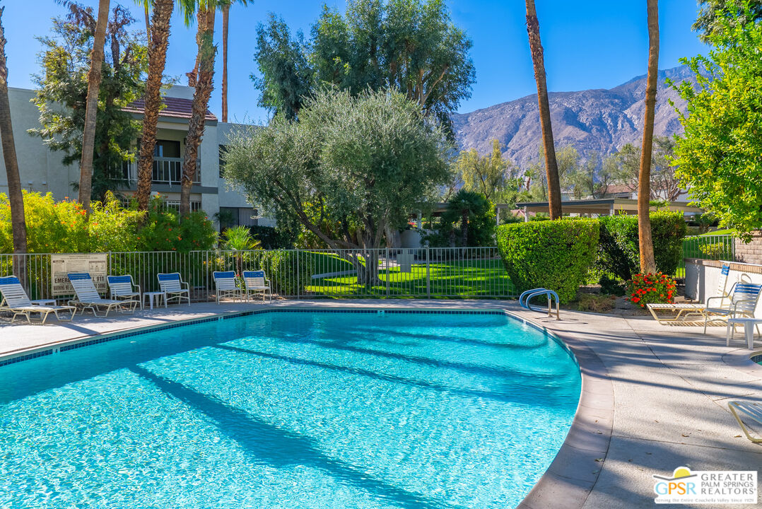 325 East Via Escuela, Unit 324 Palm Springs, CA 92262 - Photo 25 of 29 a view of backyard with swimming pool and outdoor seating