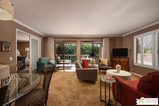 a living room with furniture a flat screen tv and a large window