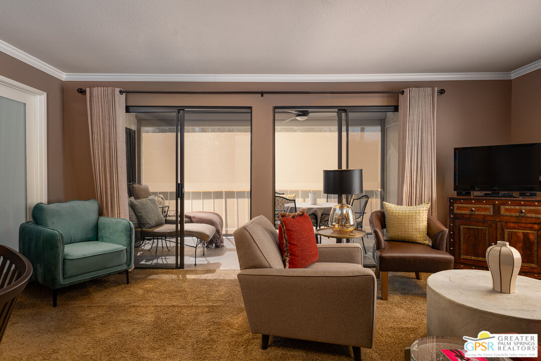 325 East Via Escuela, Unit 324 Palm Springs, CA 92262 - Photo 10 of 29 a living room with furniture and a flat screen tv