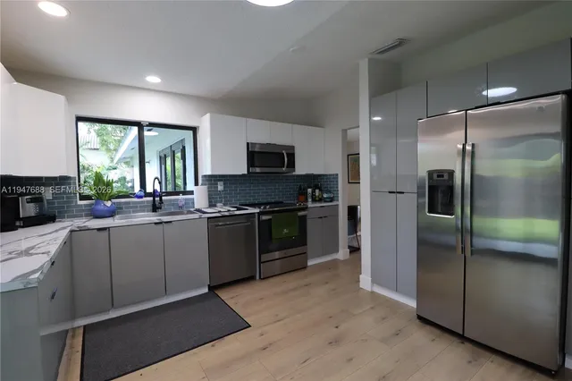 a kitchen with a refrigerator and a sink