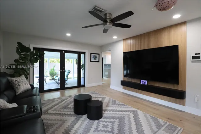 a living room with furniture and a flat screen tv