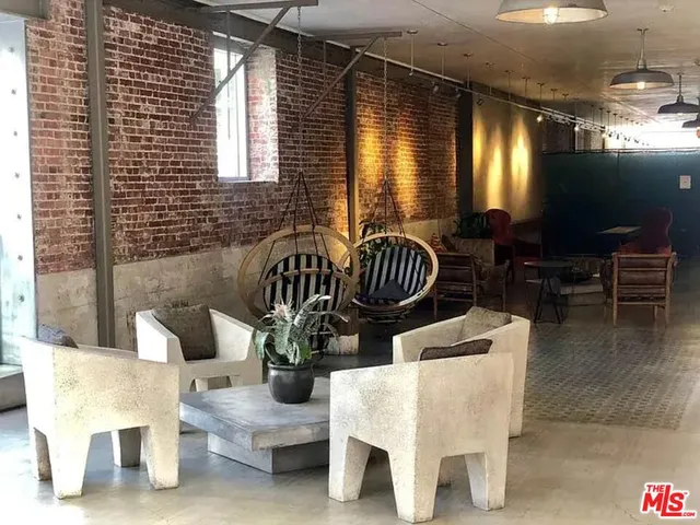 a view of balcony with dining room and hall with furniture