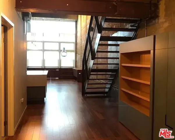 a view of entryway with stairs and wooden floor