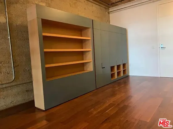 a view of a room with wooden floor