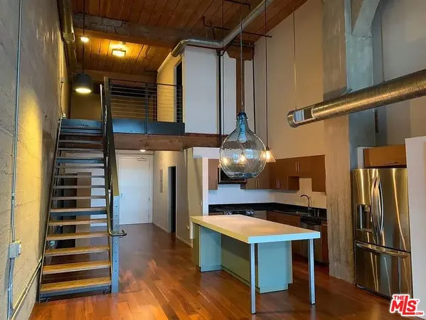 a kitchen with refrigerator and window