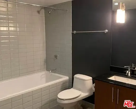 a bathroom with a toilet a sink and bathtub
