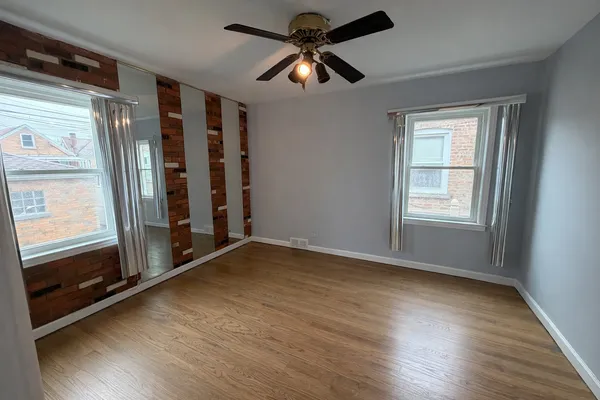 a view of room with window and wooden floor