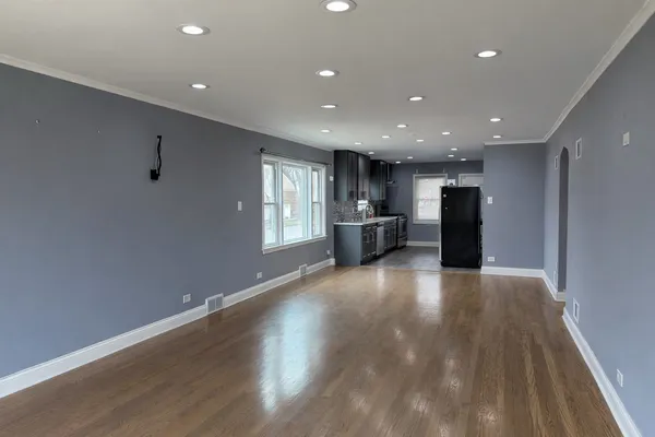a view of kitchen with refrigerator and window