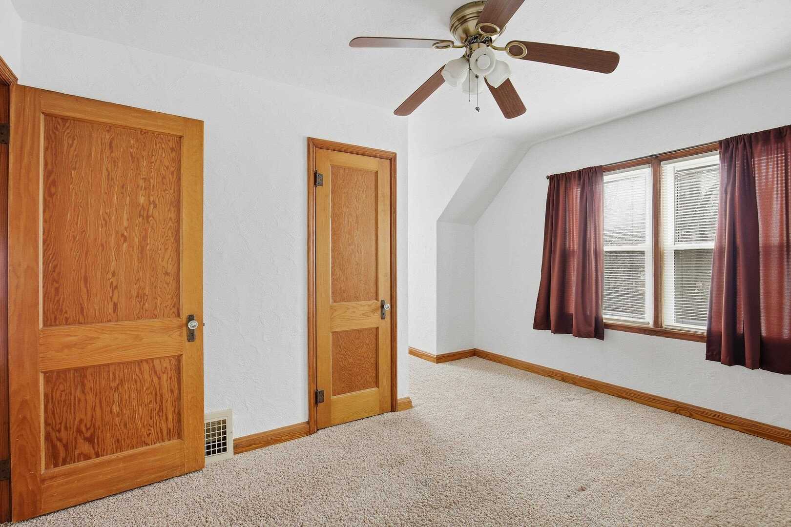 608 7th Avenue Silvis, IL 61282 - Photo 18 of 38 an empty room with windows and fan
