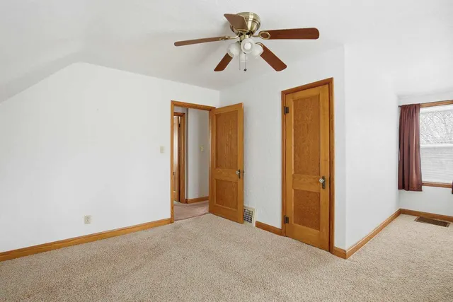 a view of a room with a ceiling fan