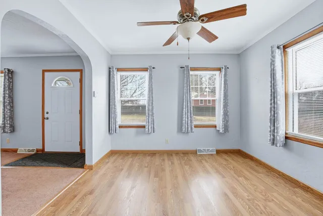 wooden floor in an empty room with a window