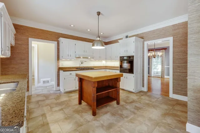 a view of empty room with wooden floor and fireplace
