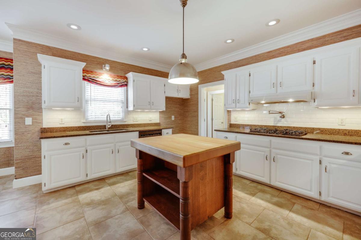 150 Walton Creek Road Athens, GA 30607 - Photo 13 of 72 a kitchen with kitchen island granite countertop a sink a counter top space appliances and cabinets