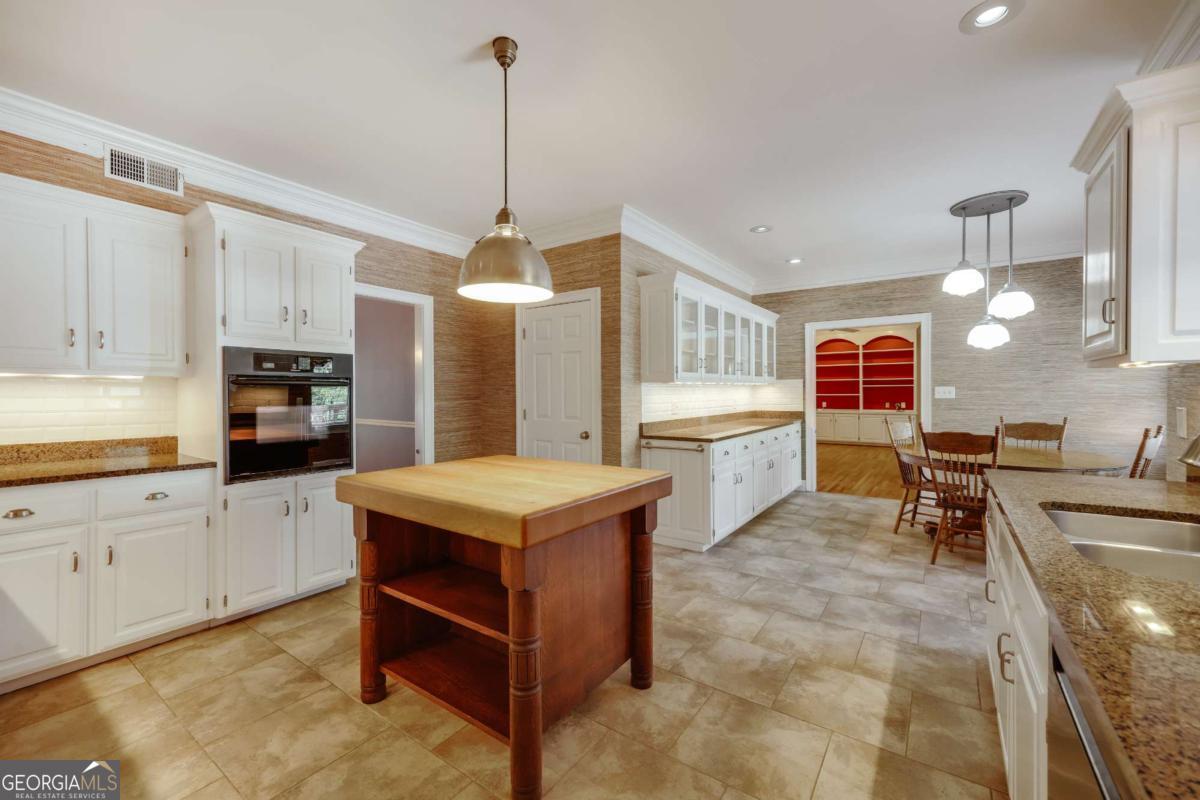 150 Walton Creek Road Athens, GA 30607 - Photo 15 of 72 a kitchen that has a lot of cabinets in it and appliances