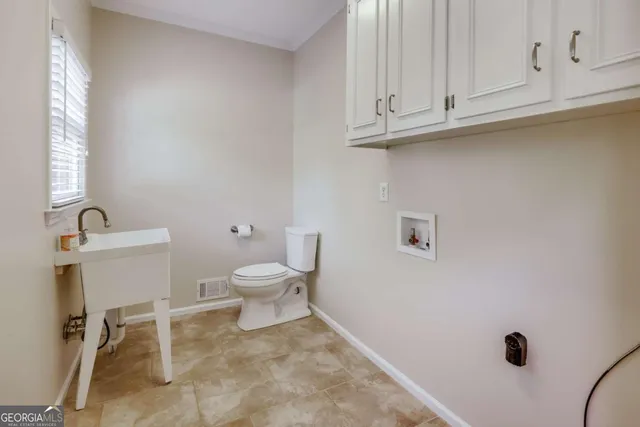 a view of a room with wooden floor and a bathroom