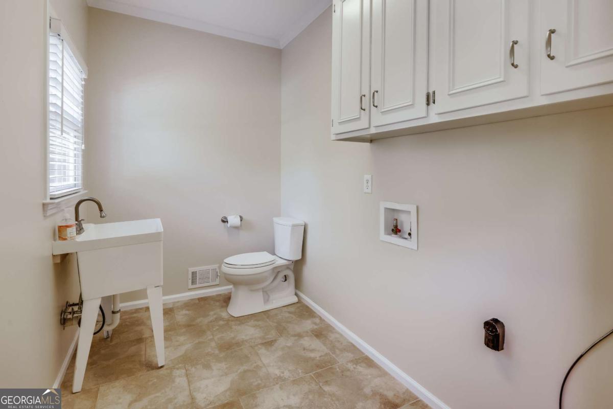 150 Walton Creek Road Athens, GA 30607 - Photo 20 of 72 a white toilet sitting next to a bathroom sink