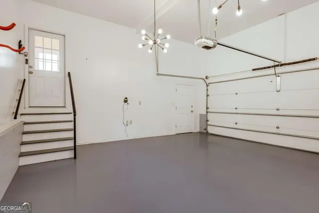 a view of a big room with wooden floor and windows