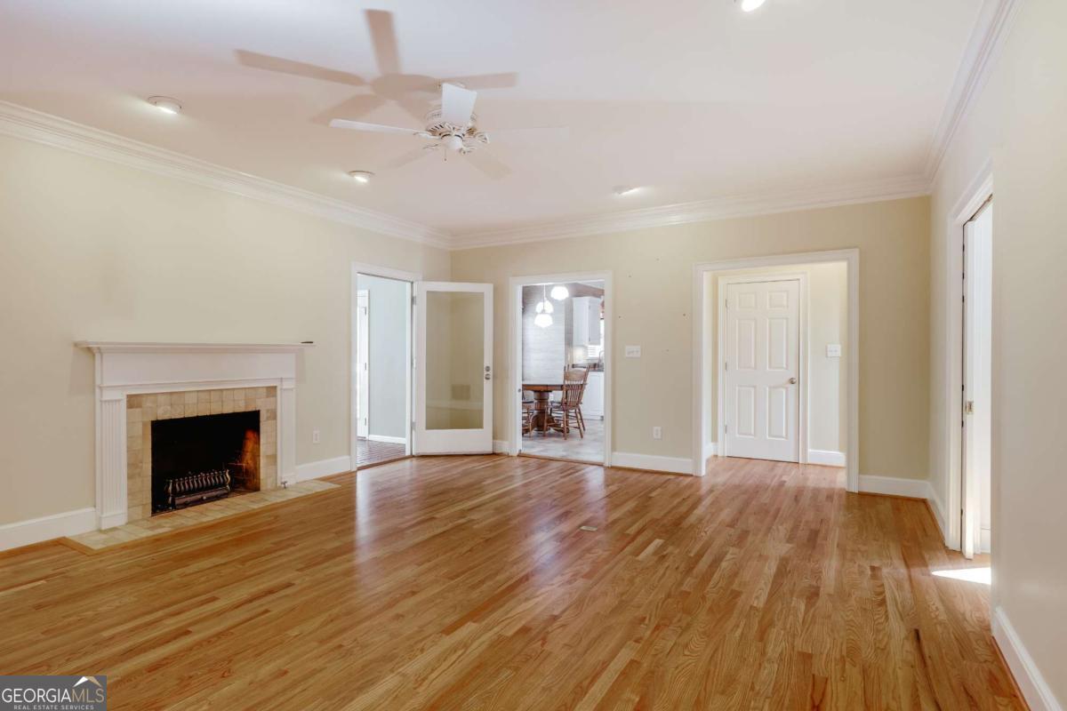 150 Walton Creek Road Athens, GA 30607 - Photo 23 of 72 a view of an empty room with wooden floor fireplace and a window