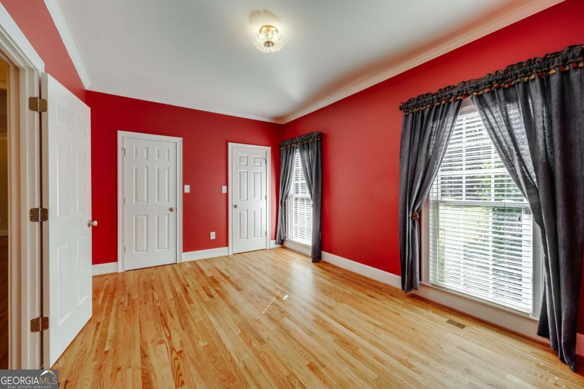 150 Walton Creek Road Athens, GA 30607 - Photo 28 of 72 a view of a big room with wooden floor and windows