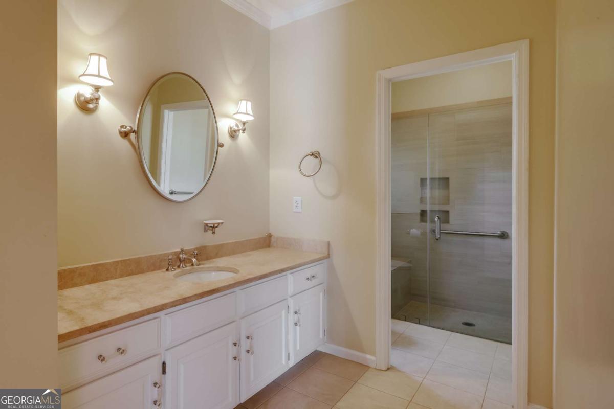 150 Walton Creek Road Athens, GA 30607 - Photo 29 of 72 a bathroom with a granite countertop sink a shower and a mirror