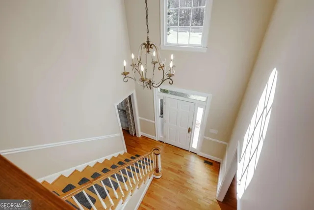 a view of a room with wooden floor and bench