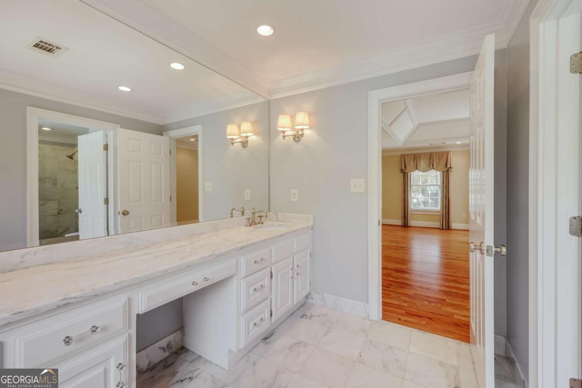 150 Walton Creek Road Athens, GA 30607 - Photo 37 of 72 a bathroom with a double vanity sink and a mirror
