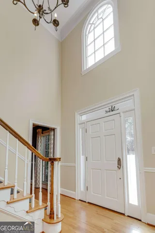 a view of staircase with wooden floor and white walls
