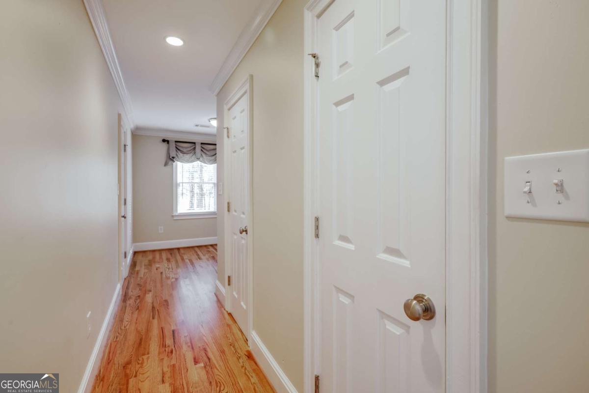 150 Walton Creek Road Athens, GA 30607 - Photo 41 of 72 a view of a hallway with wooden floor and a bathroom