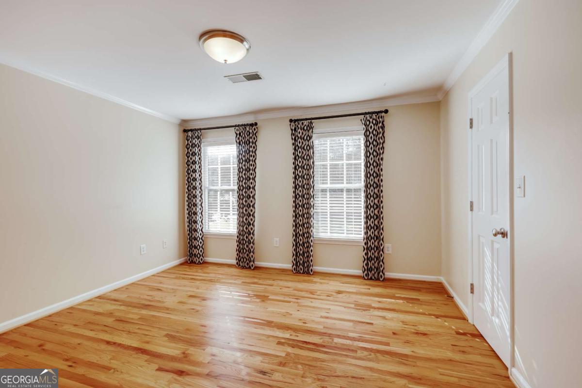 150 Walton Creek Road Athens, GA 30607 - Photo 44 of 72 an empty room with wooden floor and windows