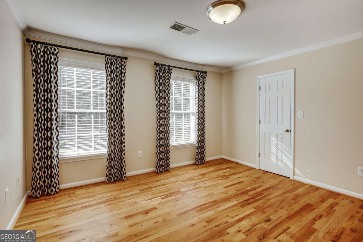 150 Walton Creek Road Athens, GA 30607 - Photo 45 of 72 a view of empty room with wooden floor and fan