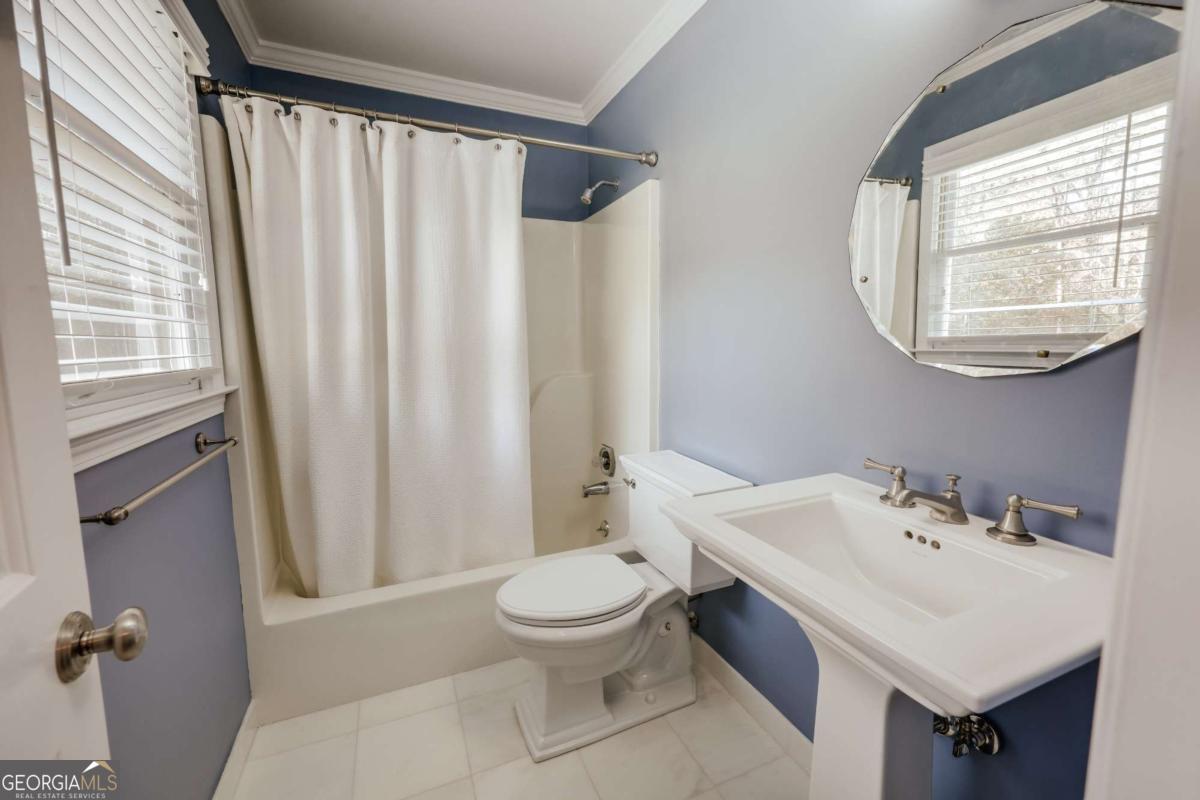 150 Walton Creek Road Athens, GA 30607 - Photo 46 of 72 a bathroom with a sink a toilet and a mirror