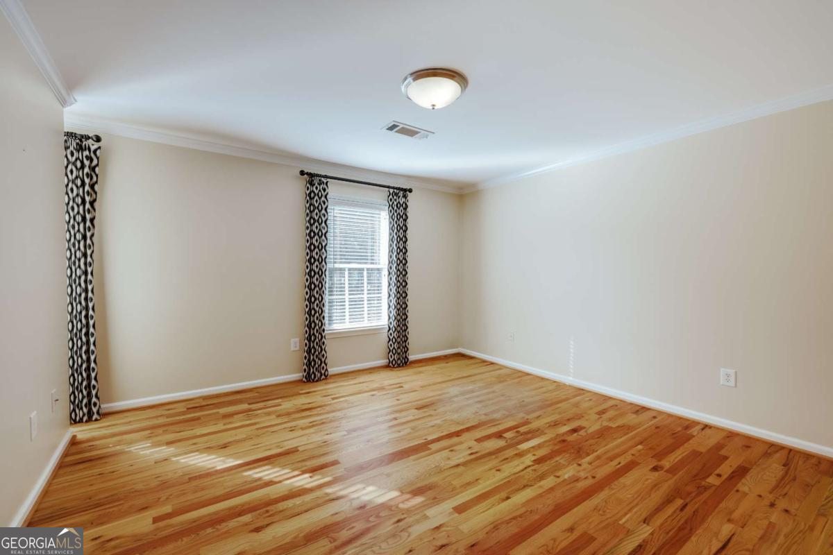 150 Walton Creek Road Athens, GA 30607 - Photo 47 of 72 a view of empty room with wooden floor and fan