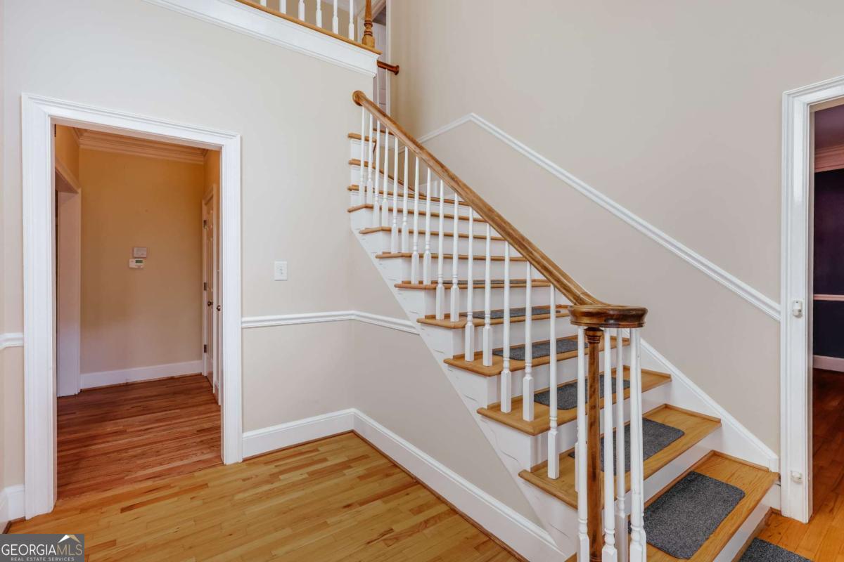 150 Walton Creek Road Athens, GA 30607 - Photo 6 of 72 a view of staircase with wooden floor and white walls