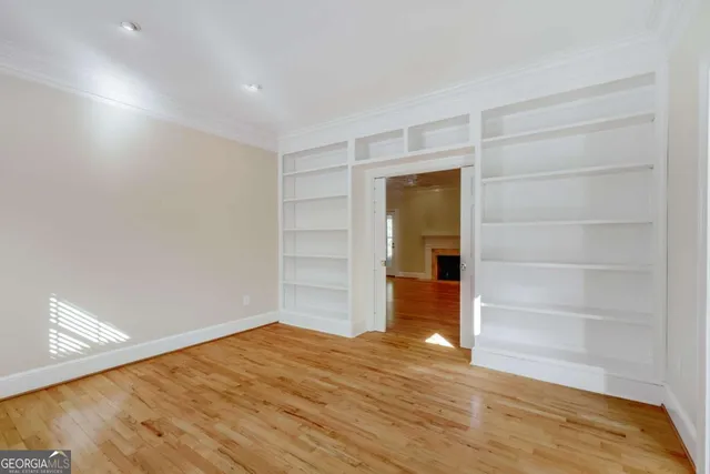 a view of a livingroom with a chandelier fan and windows
