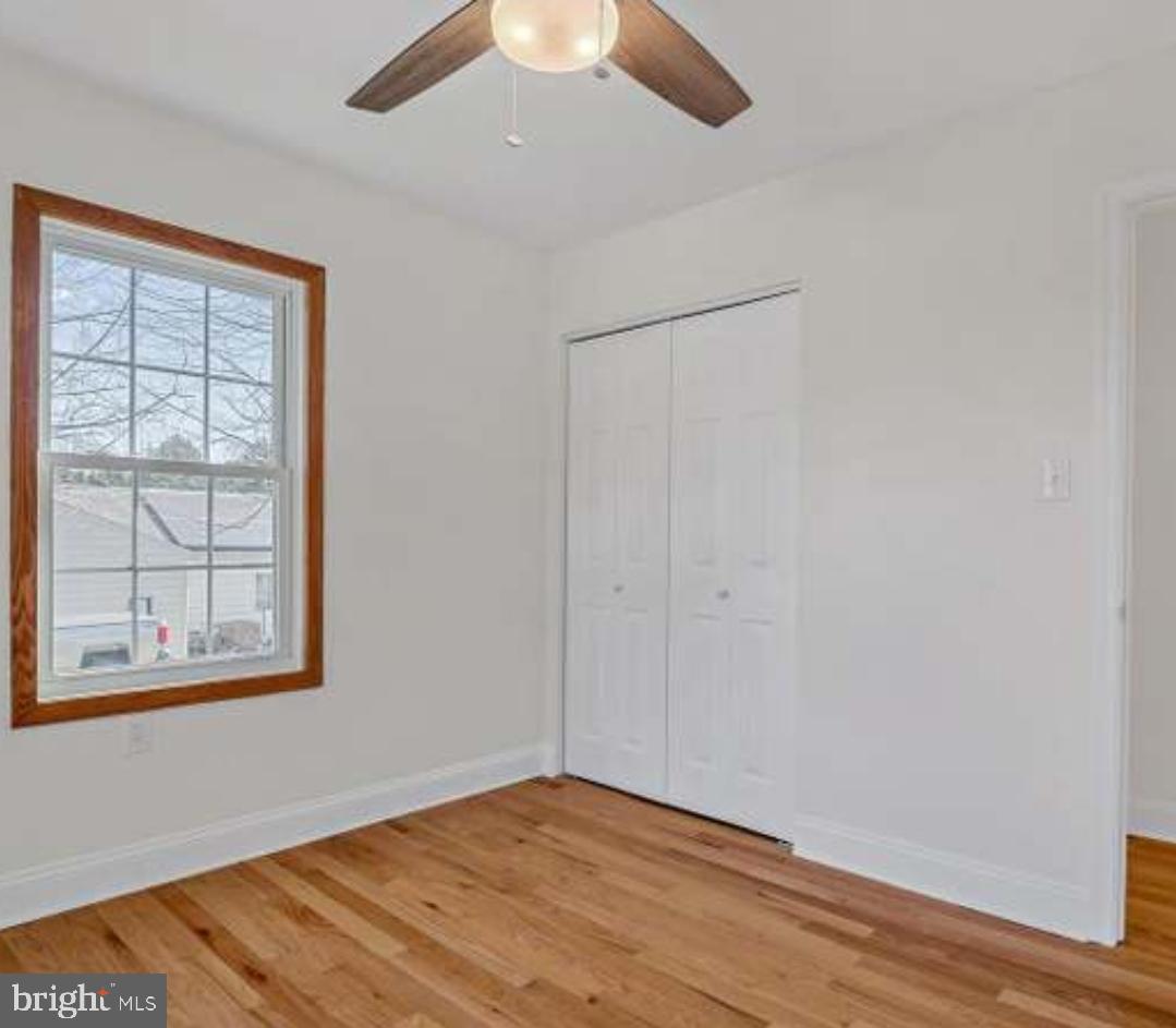40 Sandy Court Hanover, PA 17331 - Photo 10 of 19 an empty room with wooden floor closet and windows