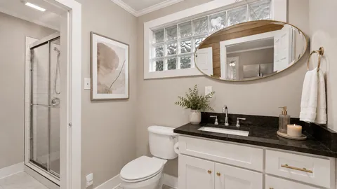a bathroom with a glass shower door