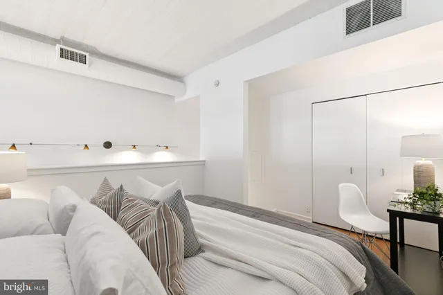 a bedroom with a bed and a table